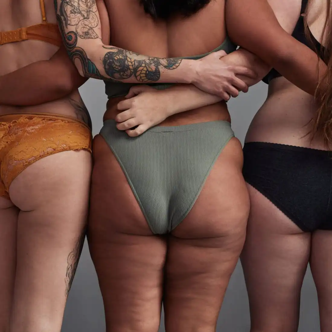 back view of women with arms around each others waist