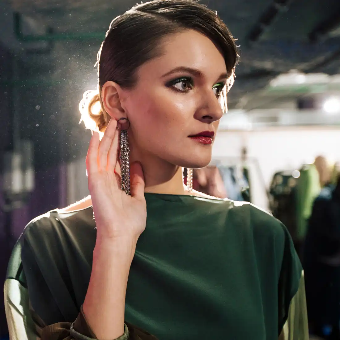 woman in green touching earring | halo laser in miami